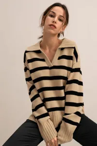 Close-up detail of the striped knit sweater featuring a chic polo collar and cozy fit.