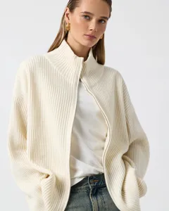 Detail view of the ribbed knit mock neck zip cardigan sweater in off-white color.