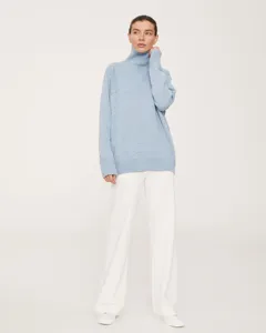 Cozy light blue turtleneck sweater detail, soft knit fabric, loose fit winter apparel look.