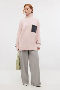 Women pink high-neck knit sweater with contrasting chest pocket, casual autumn outfit.