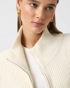 Close-up detail of women's ribbed knit half-zip cardigan collar in cream tone, soft texture.