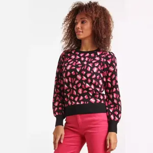 Close-up detail view of women black knit sweater featuring pink leopard jacquard sleeves.