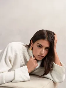 Detail view of a cozy white turtleneck sweater with elegant knit texture for autumn winter.