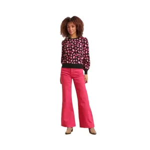 Women's leopard print knit sweater paired with pink trousers for stylish autumn wear.
