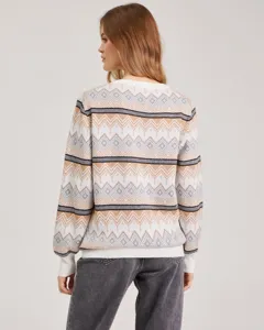 Detailed view of women's geometric jacquard knit sweater with classic patterned stripes.