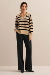 Detail view of the stylish striped knit polo sweater, featuring a relaxed fit and long sleeves.