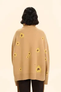 Back view detail of casual camel turtleneck knit sweater featuring cute yellow floral jacquard.
