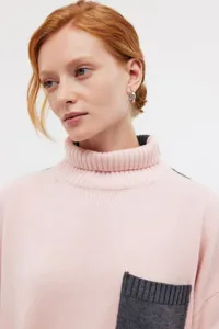 Women's pink high neck knit sweater detail view, cozy autumn winter loose pullover clothing.