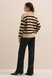 Detail shot of the striped knit polo sweater, featuring a chic collar for autumn wear.