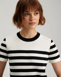 Classic black and white striped short sleeve knit sweater detail shot, soft fabric texture.
