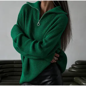 Detail view of a cozy dark green half-zip knit sweater for women, loose fit casual autumn wear.