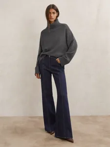 Stylish women's loose turtleneck knit sweater in dark grey, comfortable autumn winter wear.