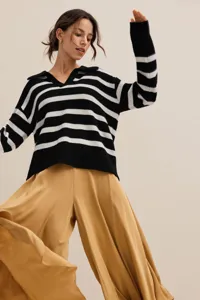 Women's black and white striped knit polo sweater with khaki wide-leg pants fashion outfit