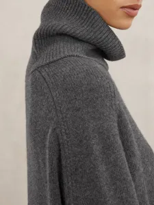 Close-up detail view of a dark grey turtleneck sweater, showing soft ribbed knit texture.