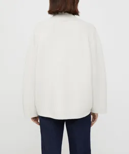 Back view detail of women's casual loose off-white turtleneck knit wool sweater outfit.