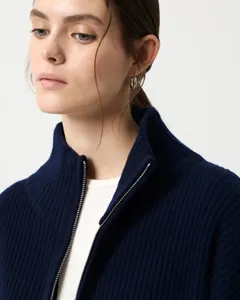 Detail view of a navy blue half turtleneck zip cardigan sweater, soft knit texture.