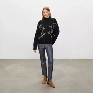 Black turtleneck knit sweater featuring delicate white floral embroidery design details.