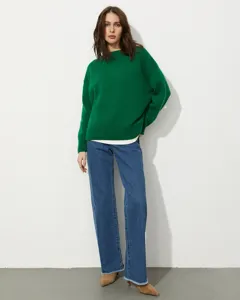 Detail shot of women's loose crewneck knit sweater, showing soft texture and cozy fit.