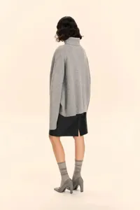 Back view detail of casual loose grey turtleneck knit sweater showcasing texture and fit.