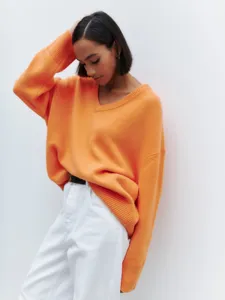 Women's orange V-neck loose long-sleeve knitted sweater, comfortable autumn fashion apparel.