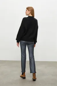 Women black turtleneck sweater back view detail, soft knit fabric style for winter daily wear.