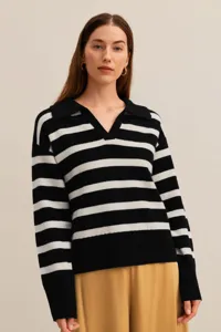 Women's black and white striped knit polo sweater, loose fit long sleeve detail view.