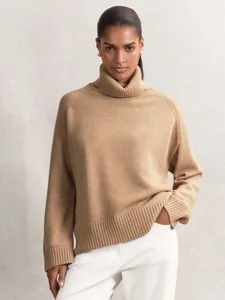 Detail shot of a women's camel high-neck loose knit sweater, cozy autumn and winter style.