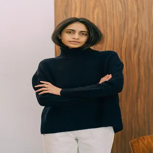 Detailed view of a cozy women's turtleneck sweater in dark blue, perfect for autumn winter.