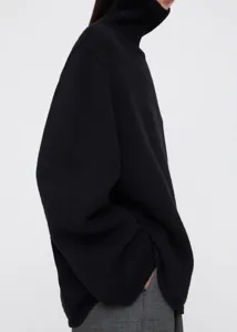 Classic black wool blend turtleneck sweater detail, featuring cozy ribbed knit texture.