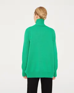 Back view detail of women's bright green high neck knit sweater, loose fit ribbed texture.