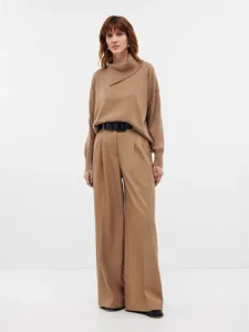 Stylish camel turtleneck sweater paired with elegant wide leg trousers and black belt.