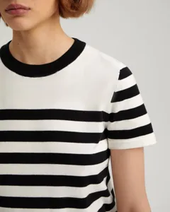 Detail view of the black and white striped short-sleeve knit sweater with round neck.