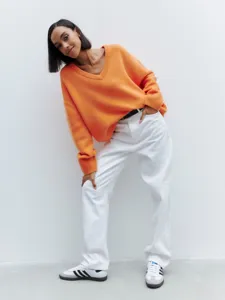 Casual orange V-neck loose long-sleeve knit sweater for women, autumn fashion style detail.