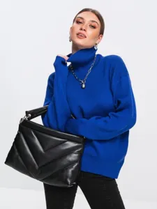 Close-up detail of a stylish blue turtleneck sweater paired with a black quilted bag.