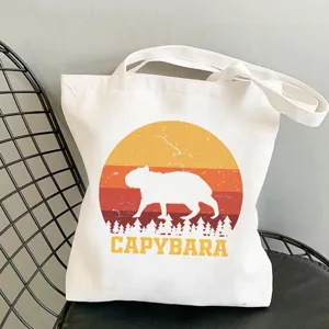 Canvas tote bag with cute capybara sunset print, casual shoulder bag for daily shopping.