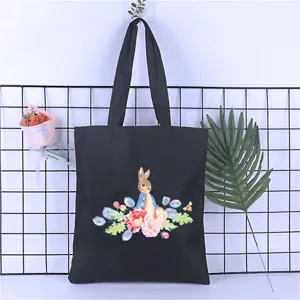 Black canvas tote bag with cute watercolor rabbit and floral print, casual student shoulder bag.