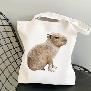 Capybara print canvas tote bag, casual shoulder bag and reusable shopping handbag.