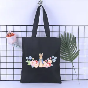 Black canvas tote bag with watercolor cute rabbit and floral print, casual shoulder bag.