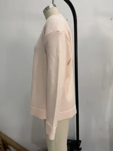 Casual pink crewneck knit sweater side view detail, comfortable autumn winter pullover top.