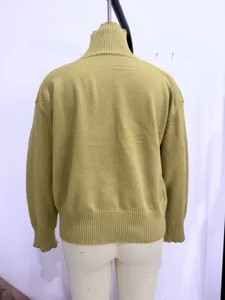 Detailed view of the back of a casual olive green turtleneck knitted sweater with ribbed hem.