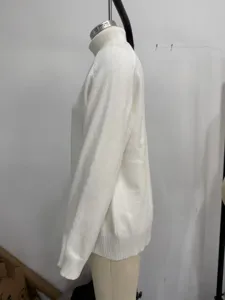 White turtleneck knit sweater detail view, cozy winter loose fit apparel side display.