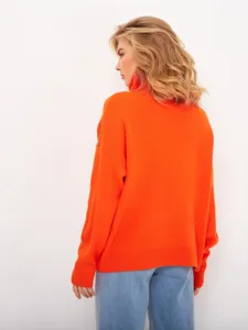 Detail view of a bright orange women turtleneck sweater, soft knit texture, cozy autumn wear.