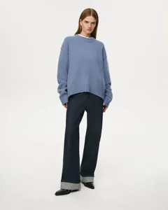 Casual women's crewneck knit sweater in soft blue shade, featuring a relaxed comfortable fit.