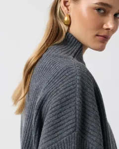 Detail view of a stylish grey ribbed high neck knit sweater for women, comfortable fit.
