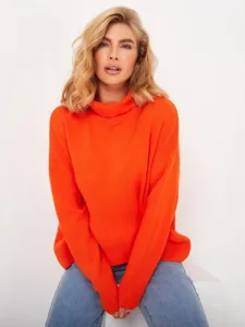 Close-up detail of women's cozy loose orange turtleneck knit sweater, soft winter wear.