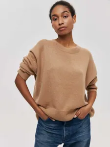Close-up detail of a women's camel crewneck knit sweater, loose fit and long sleeves.
