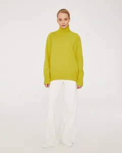 Detailed view of women's lime green high neck turtleneck sweater with long sleeves relaxed fit.
