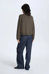 Back view detail of women casual loose high neck knit sweater in olive green color.