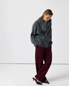 Grey ribbed half-zip knit cardigan paired with stylish trousers for a chic autumn look.