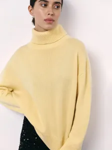 Close-up detail of soft yellow turtleneck sweater, cozy knit texture, comfortable autumn style.